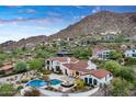 Exterior showcasing the property's tile roof, pool, manicured landscaping, and mountainous backdrop at 4743 N 54Th St, Phoenix, AZ 85018