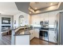 Bright kitchen with white cabinets, stainless steel appliances, and a gray countertop peninsula at 705 W Queen Creek Rd # 2158, Chandler, AZ 85248