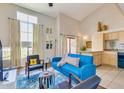 Cozy living room with large windows, blue sofa, and a view of the adjacent kitchen at 1005 E 8Th St # 3017, Tempe, AZ 85281