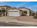 Charming single-story home with a two car garage, desert landscaping, and neutral stucco exterior at 11040 W Hayward Ave, Glendale, AZ 85307