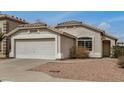 Charming single-story home with a two car garage, desert landscaping, and neutral stucco exterior at 11040 W Hayward Ave, Glendale, AZ 85307