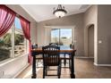 Cozy dining area with a view of the backyard, a hanging light fixture and large windows at 14822 N Tonya Cir, El Mirage, AZ 85335