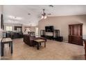 Spacious living room with a ceiling fan, tile flooring, and an open floor plan at 14822 N Tonya Cir, El Mirage, AZ 85335