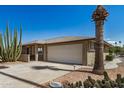 Attractive home boasting a large garage, desert landscaping, and an extra wide driveway at 15227 N Rosewood Dr, Sun City, AZ 85351