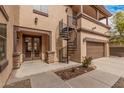 Side exterior view featuring a spiral staircase, a double-door entrance, and a well-maintained yard at 15322 W Montecito Ave, Goodyear, AZ 85395