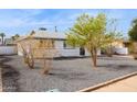 Single-story home featuring a low maintenance front yard with stone landscaping at 1747 W Belfast St, Mesa, AZ 85201