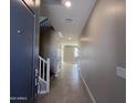 Inviting foyer featuring tiled floors and a staircase leading to the upper level of the home at 17541 W Lupine Ave, Goodyear, AZ 85338