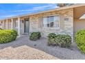 Close up exterior of a single Gathering home with desert landscaping and a well kept lawn at 18402 N 94Th Dr, Sun City, AZ 85373