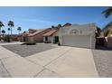 Inviting single-Gathering home with desert landscaping, a two-car garage, and a red tile roof at 18660 N 71St Ln, Glendale, AZ 85308