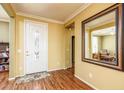 Welcoming entryway with neutral paint, wood floors, and large mirror for a spacious feel at 20449 N Lemon Drop Dr, Maricopa, AZ 85138