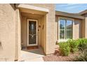 Inviting front entrance with security door, desert landscaping, and covered entry way at 20449 N Lemon Drop Dr, Maricopa, AZ 85138