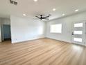 Open living room featuring luxury vinyl plank floors, recessed lighting, and modern door at 2101 S Meridian Rd # 42, Apache Junction, AZ 85120