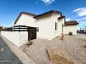 A nice house with desert landscaping, walled side yard, and a brown tile roof at 2101 S Meridian Rd # 42, Apache Junction, AZ 85120