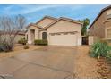 Charming single-Gathering home featuring a low-maintenance desert landscape and a two-car garage at 26065 N 68Th Ln, Peoria, AZ 85383