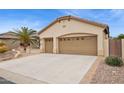 Lovely home showcasing a three-car garage with decorative doors and a concrete driveway at 2634 N 164Th Ave, Goodyear, AZ 85395