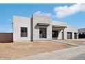 Contemporary home featuring a stone accent wall, black trim and a two car garage at 33949 N Borgata Trl, San Tan Valley, AZ 85144