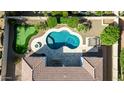 Aerial view of backyard featuring a lush green putting green and a custom-shaped private pool at 4102 E Crescent Way, Chandler, AZ 85249