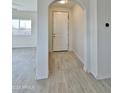 Bright foyer with neutral tile flooring, white walls, and a view into the living space at 4240 N Arizona Rd, Eloy, AZ 85131