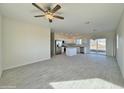 Spacious open floor plan with a ceiling fan, tile flooring, and natural light at 4240 N Arizona Rd, Eloy, AZ 85131