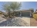 Attractive home with desert landscaping, a tiled roof, and a spacious two-car garage at 4315 W Phalen Dr, New River, AZ 85087