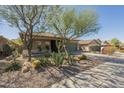 Inviting home featuring low-maintenance desert landscaping and a well-manicured front yard at 4315 W Phalen Dr, New River, AZ 85087