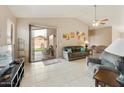 Comfortable living room with tiled floors and sliding door access to the backyard at 43870 W Baker Dr, Maricopa, AZ 85138