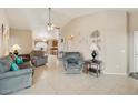 Bright and airy living room featuring neutral paint, ceiling fan, and tile flooring at 43870 W Baker Dr, Maricopa, AZ 85138