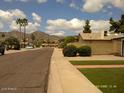 Neighborhood street view showcasing a tidy street and desert landscaping with a mountain backdrop at 4606 E Cheyenne Dr, Phoenix, AZ 85044