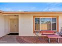 Inviting front entrance with a secure screen door, tiled patio, and seating area at 5255 W Caribbean Ln, Glendale, AZ 85306