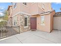 Charming townhome entrance featuring stone accents, a fenced front porch, and a welcoming 'HELLO' doormat at 7815 W Monte Vista Rd, Phoenix, AZ 85035