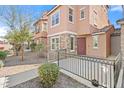 Beautiful townhome boasting stone accents, a wrought-iron fenced front porch, and manicured landscaping at 7815 W Monte Vista Rd, Phoenix, AZ 85035