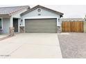 Home featuring a two car garage and a well-kept xeriscaped front yard at 8139 W Columbine Dr, Peoria, AZ 85381