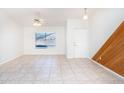 Bright, empty living room with tile flooring, a window, and fresh, white paint at 8818 N 110Th Ave, Peoria, AZ 85345