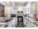 Modern kitchen with white cabinets, stainless steel appliances, and granite countertops at 11011 N 92Nd St # 1157, Scottsdale, AZ 85260