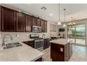 Modern kitchen featuring stainless steel appliances, an island, and dark wood cabinets at 11023 E Shepperd Ave, Mesa, AZ 85212