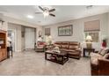 Comfortable living room with neutral tones, tile floors, and cozy seating arrangement at 11023 E Shepperd Ave, Mesa, AZ 85212