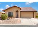 Charming single-story home featuring a tile roof and well-maintained desert landscaping for easy maintenance at 12007 S Crow Ct, Phoenix, AZ 85044