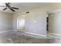Spacious living room featuring ceiling fan, neutral walls, and doorway to adjacent room at 1518 N Gilbert Ave, Casa Grande, AZ 85122