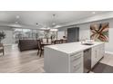 Bright, open-concept living space with modern kitchen, dining area, and comfortable seating featuring light wood floors at 16580 N 92Nd St # 2003, Scottsdale, AZ 85260