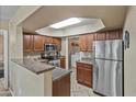 Spacious kitchen featuring a stainless steel refrigerator and a convenient laundry area at 17017 N 12Th St # 1106, Phoenix, AZ 85022