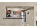 Open kitchen design with modern appliances and adjacent laundry room for convenience at 17017 N 12Th St # 1106, Phoenix, AZ 85022
