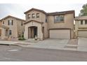 Inviting two-story home with a covered porch, two-car garage, and low-maintenance desert landscaping at 17062 N 184Th Dr, Surprise, AZ 85374