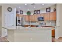 Bright kitchen features stainless appliances, granite counters, and light wood cabinetry at 17062 N 184Th Dr, Surprise, AZ 85374