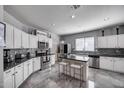Modern kitchen featuring stainless steel appliances, a center island, and stylish tile backsplash at 17916 N 183Rd Ave, Surprise, AZ 85374