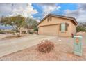 Attractive home featuring desert landscaping, a three-car garage, and a neutral-colored exterior at 188 N Nueva Ln, Casa Grande, AZ 85194