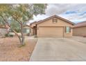 Attractive home featuring desert landscaping, a two-car garage, and a neutral-colored exterior at 188 N Nueva Ln, Casa Grande, AZ 85194