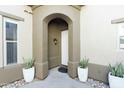 Inviting front entrance with potted plants, adding a touch of warmth and sophistication at 20802 N Grayhawk Dr # 1151, Scottsdale, AZ 85255