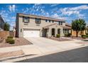 Beautiful home with a well-manicured lawn, a two-car garage, and a spacious driveway at 21030 E Misty Ln, Queen Creek, AZ 85142