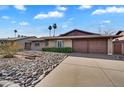 Exterior front view of a single-story home with a well-maintained lawn and beautiful blue sky at 2123 E Radcliffe Dr, Tempe, AZ 85283