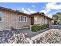 A well-maintained, light brick home featuring desert landscaping and a cozy front entrance at 2123 E Radcliffe Dr, Tempe, AZ 85283